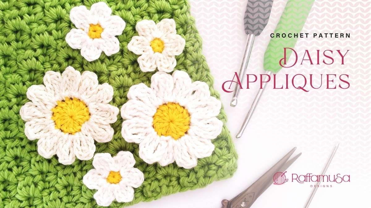 White and yellow crochet daisy appliques in two sizes resting on a green crochet square, from Raffamusa Designs
