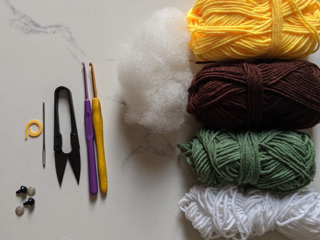Milk cotton yarn in brown, green, yellow, black and white with two crochet hooks and safety eyes