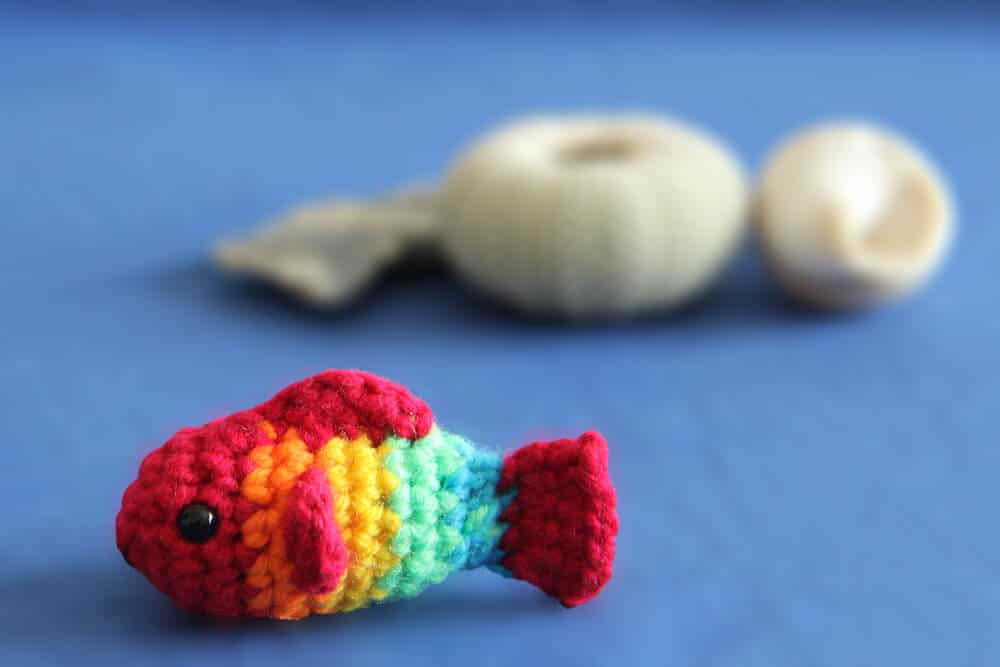 Two small no sew crochet fish keychains in pink and green, by Chai Coffee Crochet