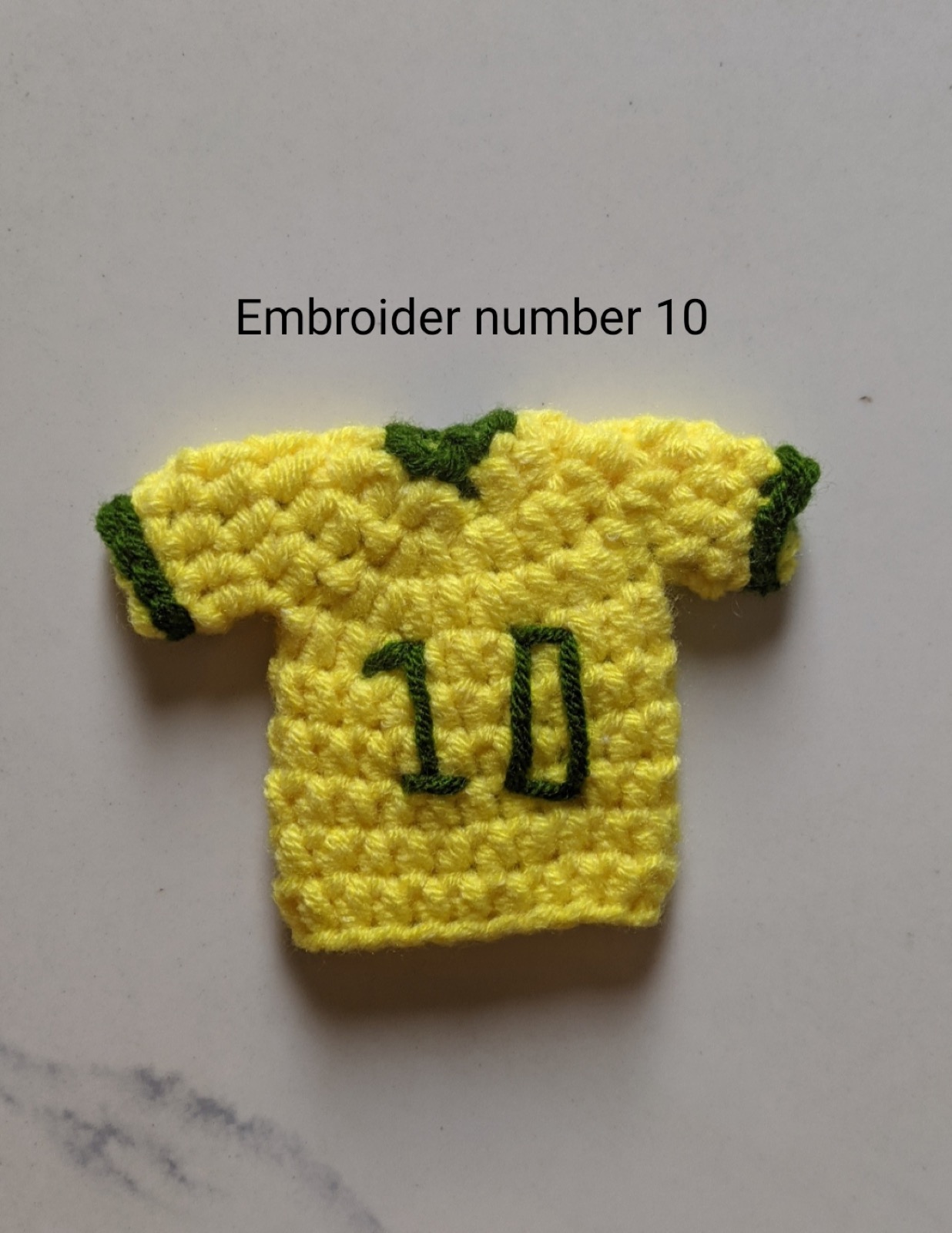 The finished yellow jersey with a large green number 10 embroidered across the chest