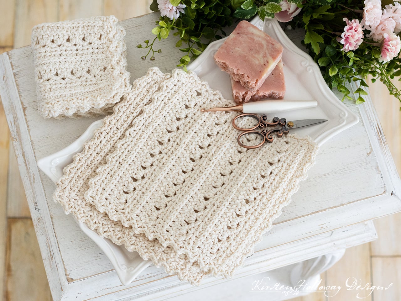 A square cotton crochet dishcloth with a textured primrose stitch pattern, designed by Kirsten Holloway Designs