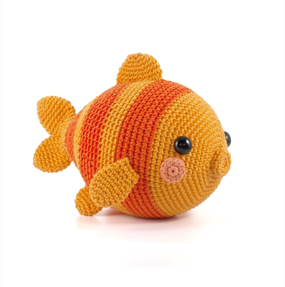 Round striped crochet goldfish in light and dark orange with pink cheeks and orange fins on a white background